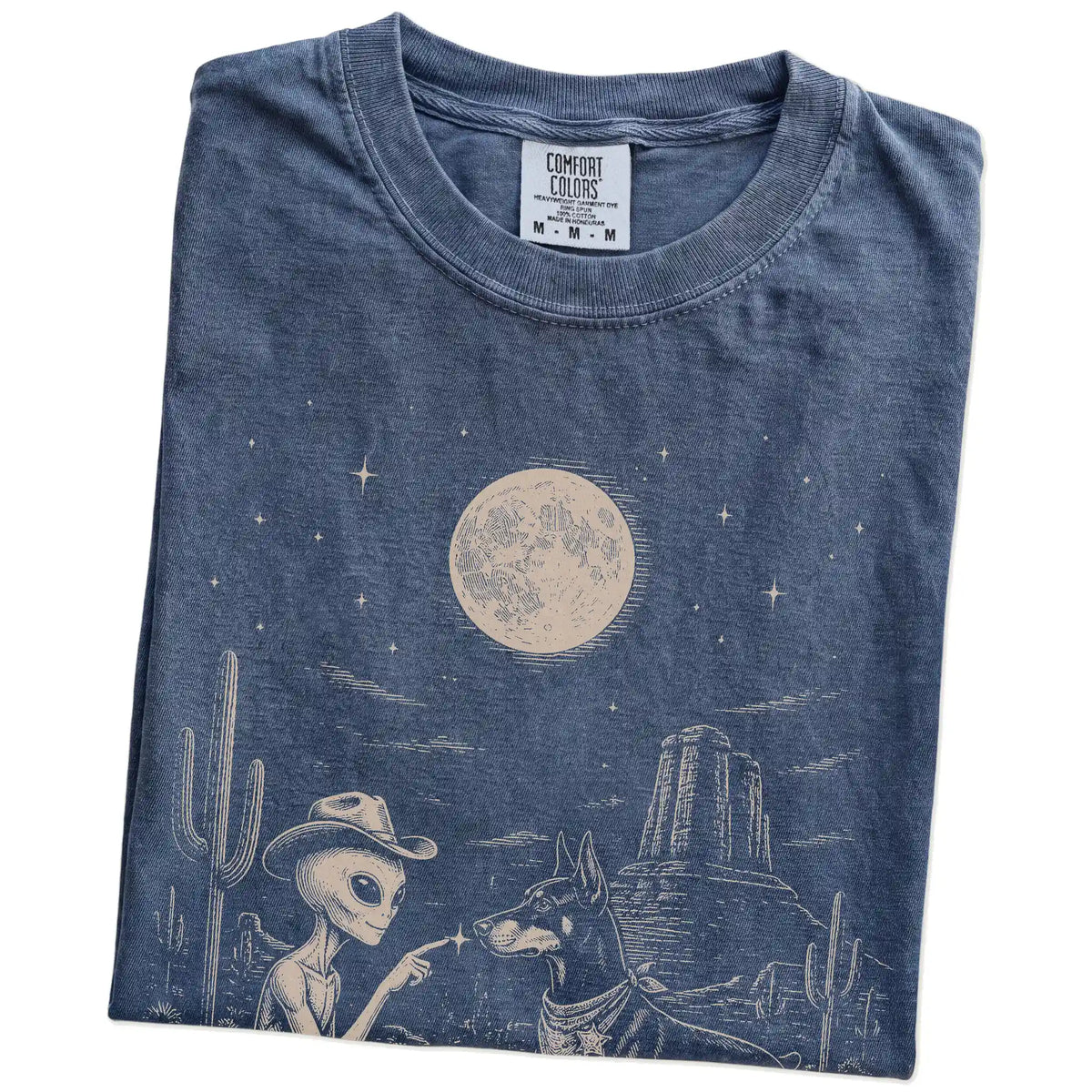 Folded Denim Comfort Colors® T-shirt showing cowboy alien fist-bumping a doberman beneath the moon