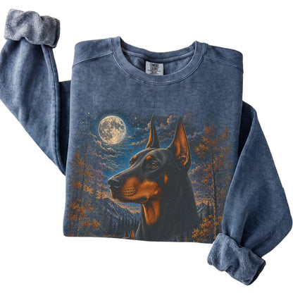 Folded denim sweatshirt with Doberman Autumn Moon artwork.