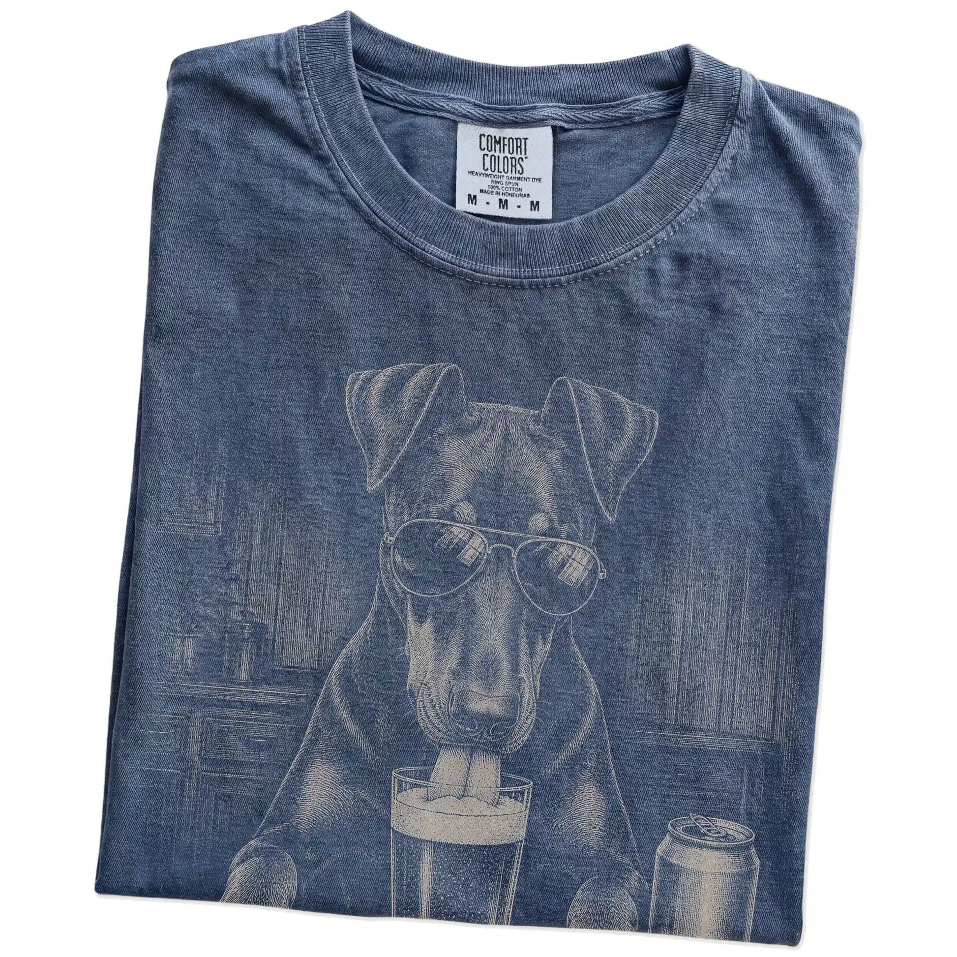 Folded Denim Comfort Colors® t-shirt showing Doberman sneaking a drink from a pint