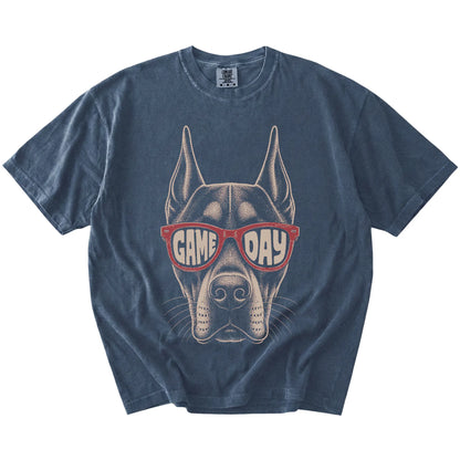 Doberman wearing red Game Day sunglasses on a Denim Comfort Colors® T-shirt