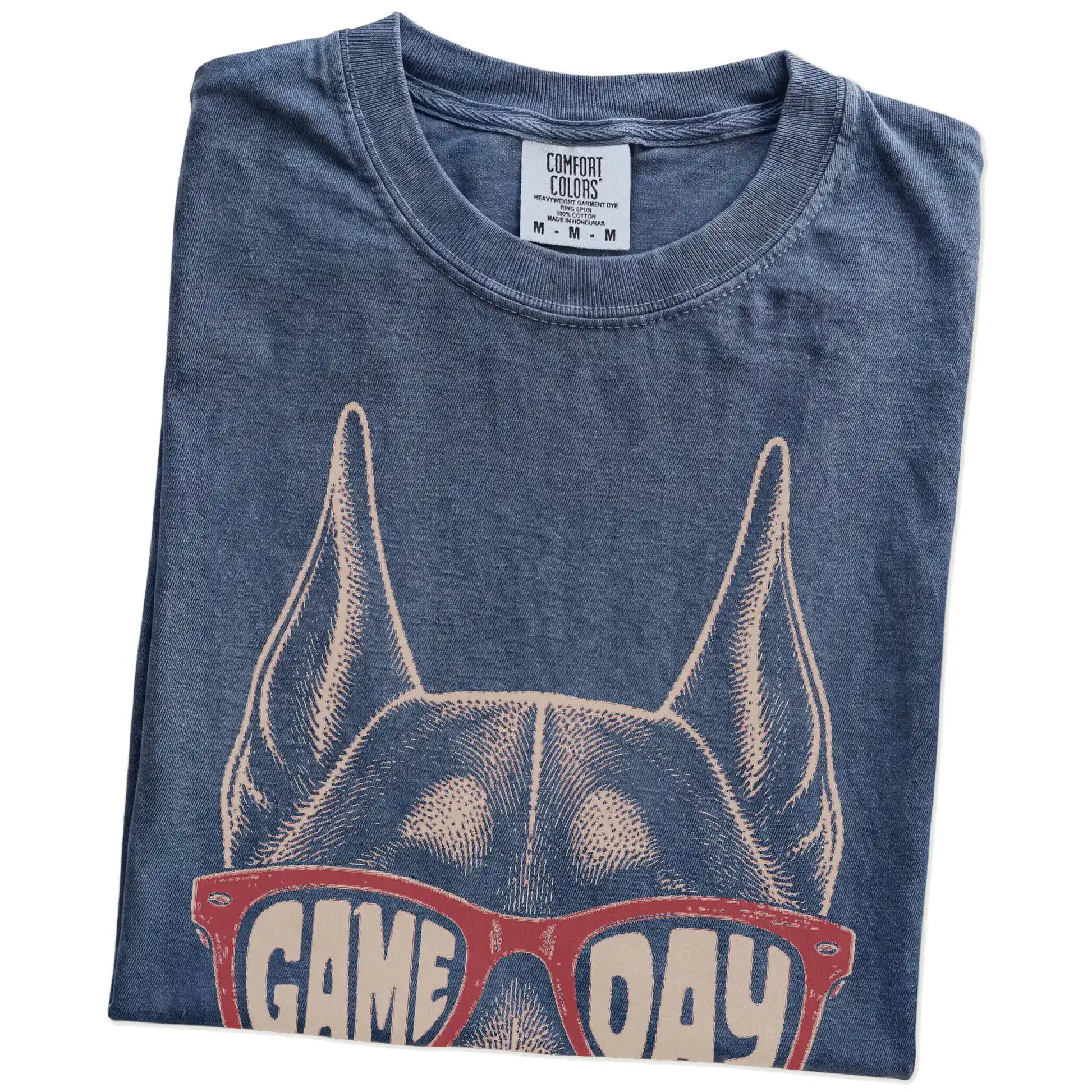 Folded Denim Comfort Colors® T-shirt showing doberman wearing red game day sunglasses