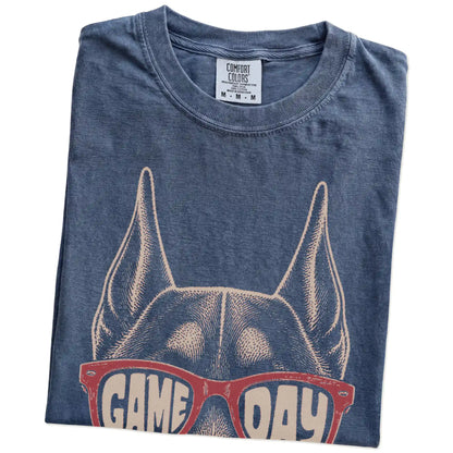 Folded Denim Comfort Colors® T-shirt showing doberman wearing red game day sunglasses