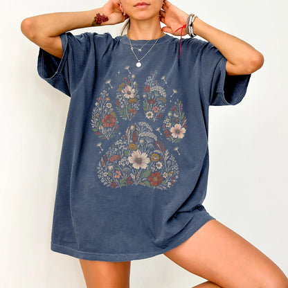Person wearing a Denim T-shirt with dried flower paw print