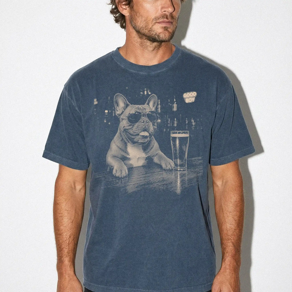 Denim Frenchie at a bar beside a pint, worn in a studio setting