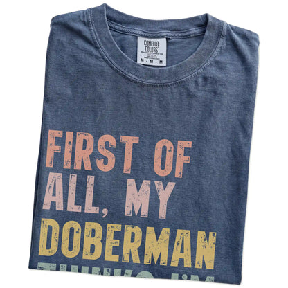 Folded Denim Comfort Colors® T-shirt showing “My Doberman thinks I’m delightful” text