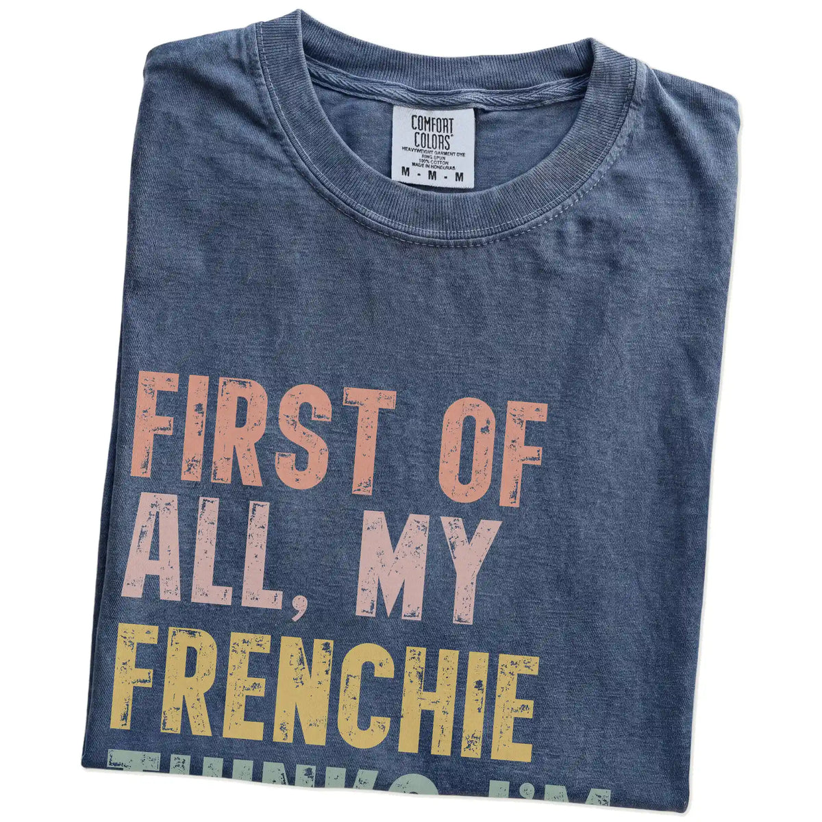 Folded Denim Comfort Colors® T-shirt showing “My French Bulldog thinks I’m delightful” text