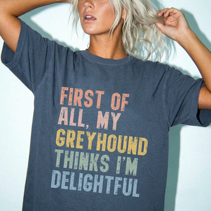 Model wearing a Denim Comfort Colors® T-shirt with “My Greyhound thinks I’m delightful” text