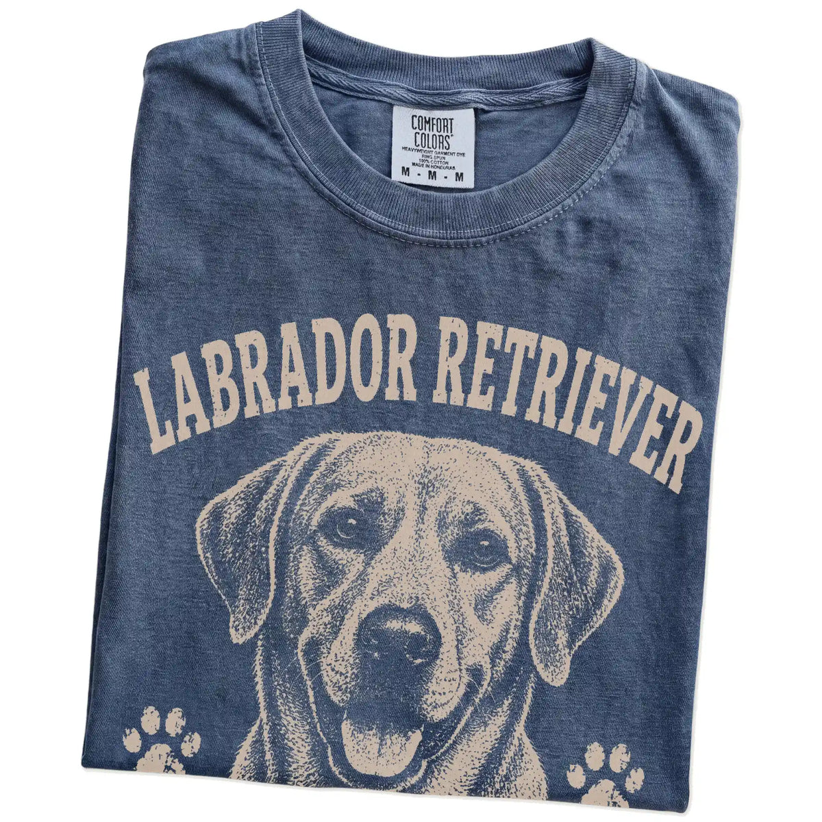 Folded Denim Comfort Colors® T-shirt showing Labrador Retriever design with “Food Motivated & Proud Of It” lettering