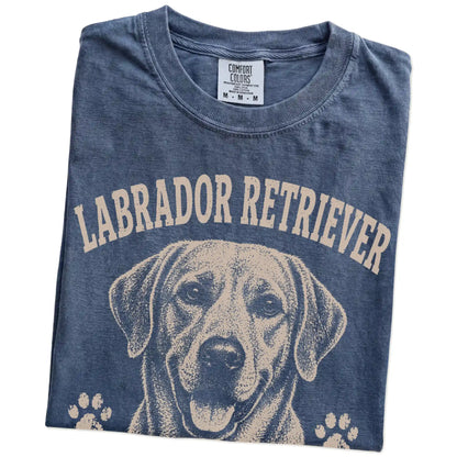 Folded Denim Comfort Colors® T-shirt showing Labrador Retriever design with “Food Motivated & Proud Of It” lettering