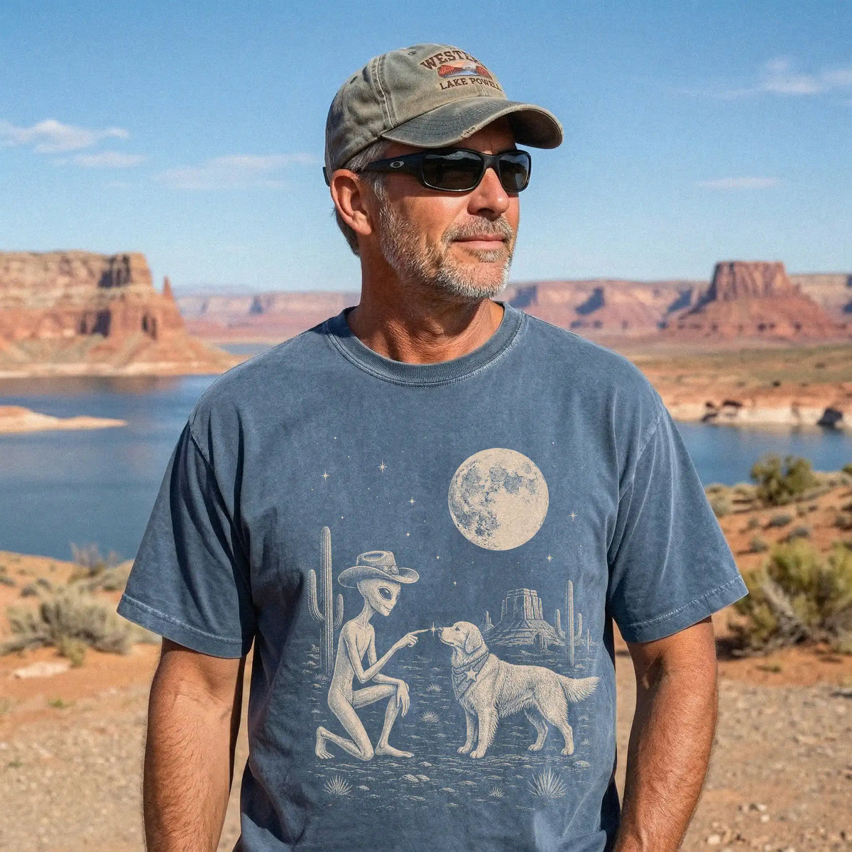 Model wearing a Denim Comfort Colors® T-shirt with cowboy alien fist-bumping a golden retriever beneath the moon