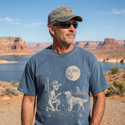 Model wearing a Denim Comfort Colors® T-shirt with cowboy alien fist-bumping a golden retriever beneath the moon