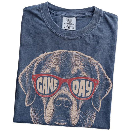 Folded Denim Comfort Colors® T-shirt showing golden retriever wearing red game day sunglasses