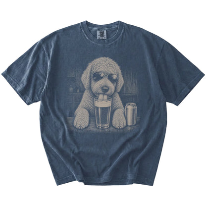 Goldendoodle sneaking a drink from a foamy pint at home on a Denim Comfort Colors® t-shirt
