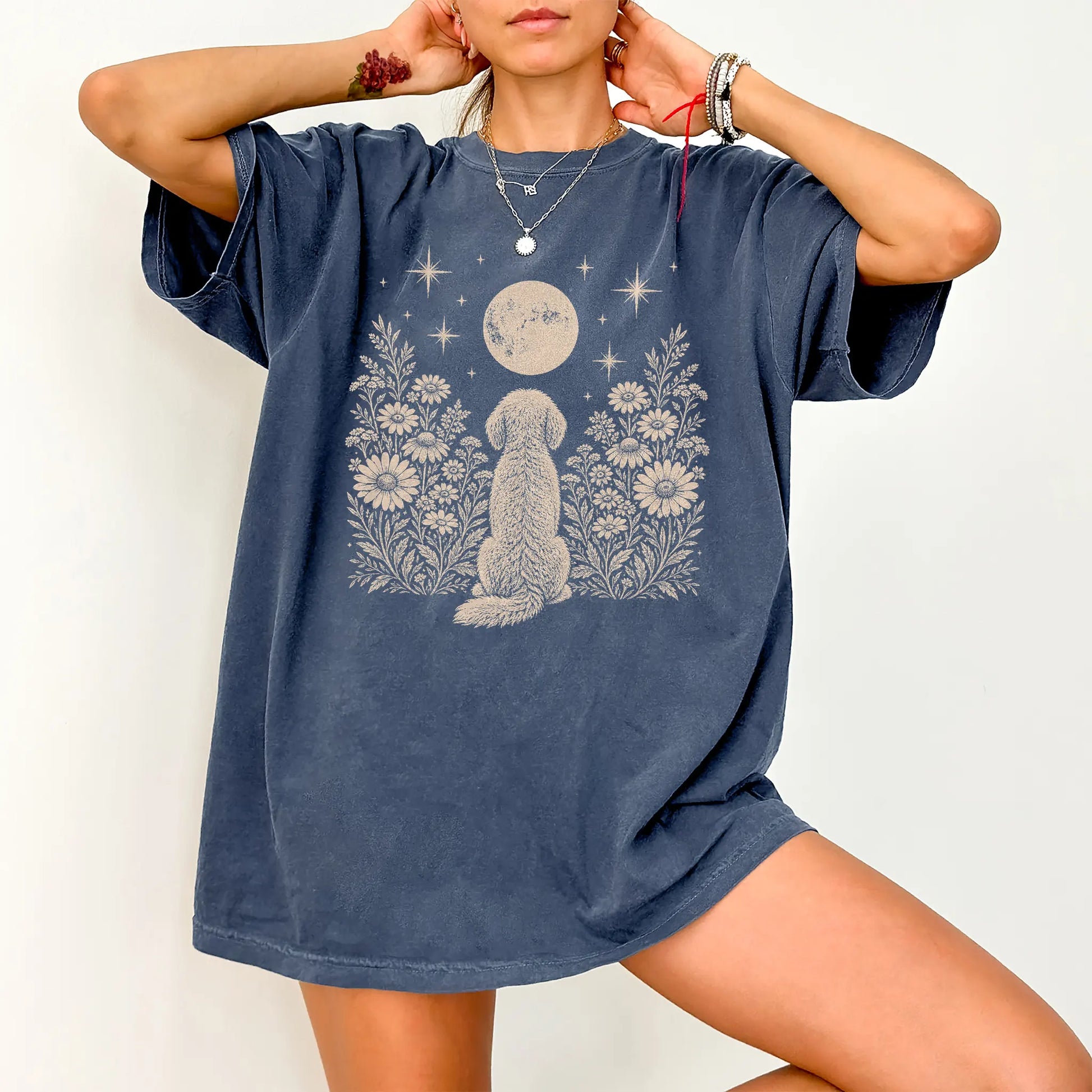 Model wearing a Denim Comfort Colors® T-shirt featuring Goldendoodle beneath a wildflower moon