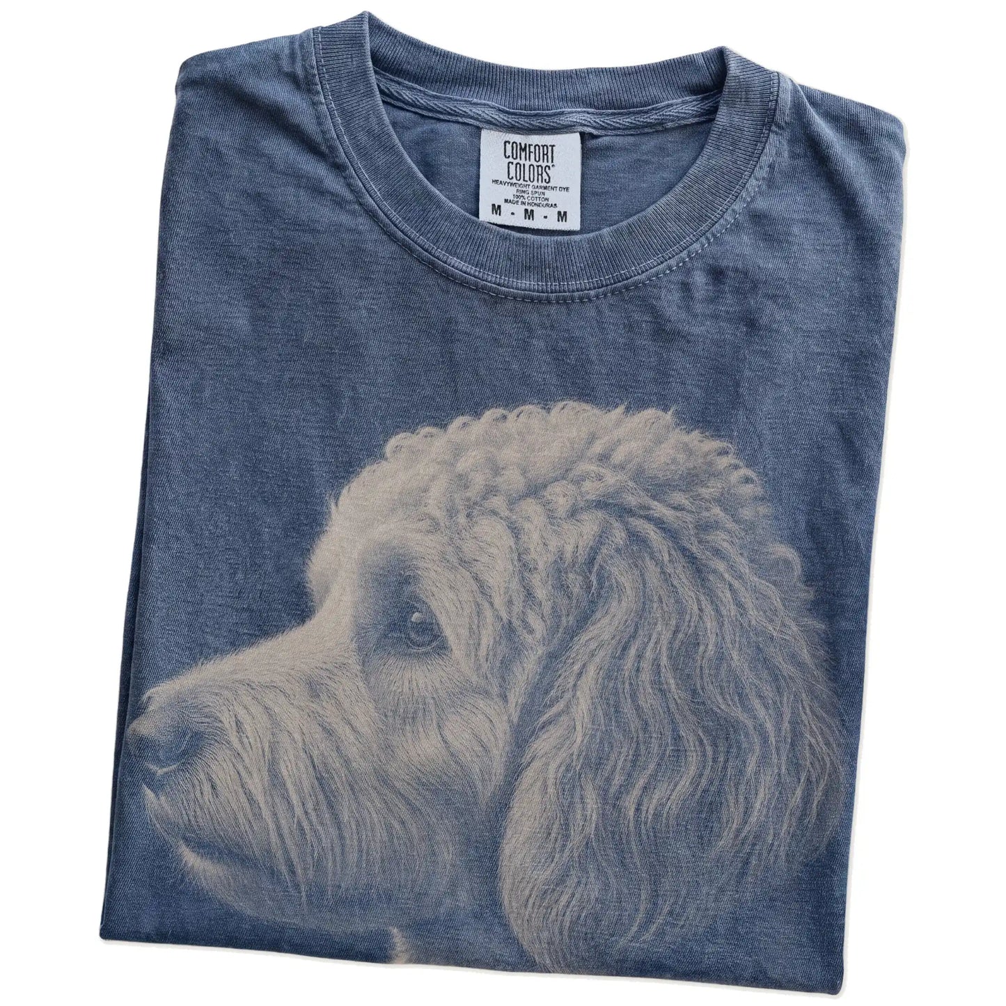 Folded Denim Comfort Colors® T-shirt showing a detailed photographic portrait of a Goldendoodle