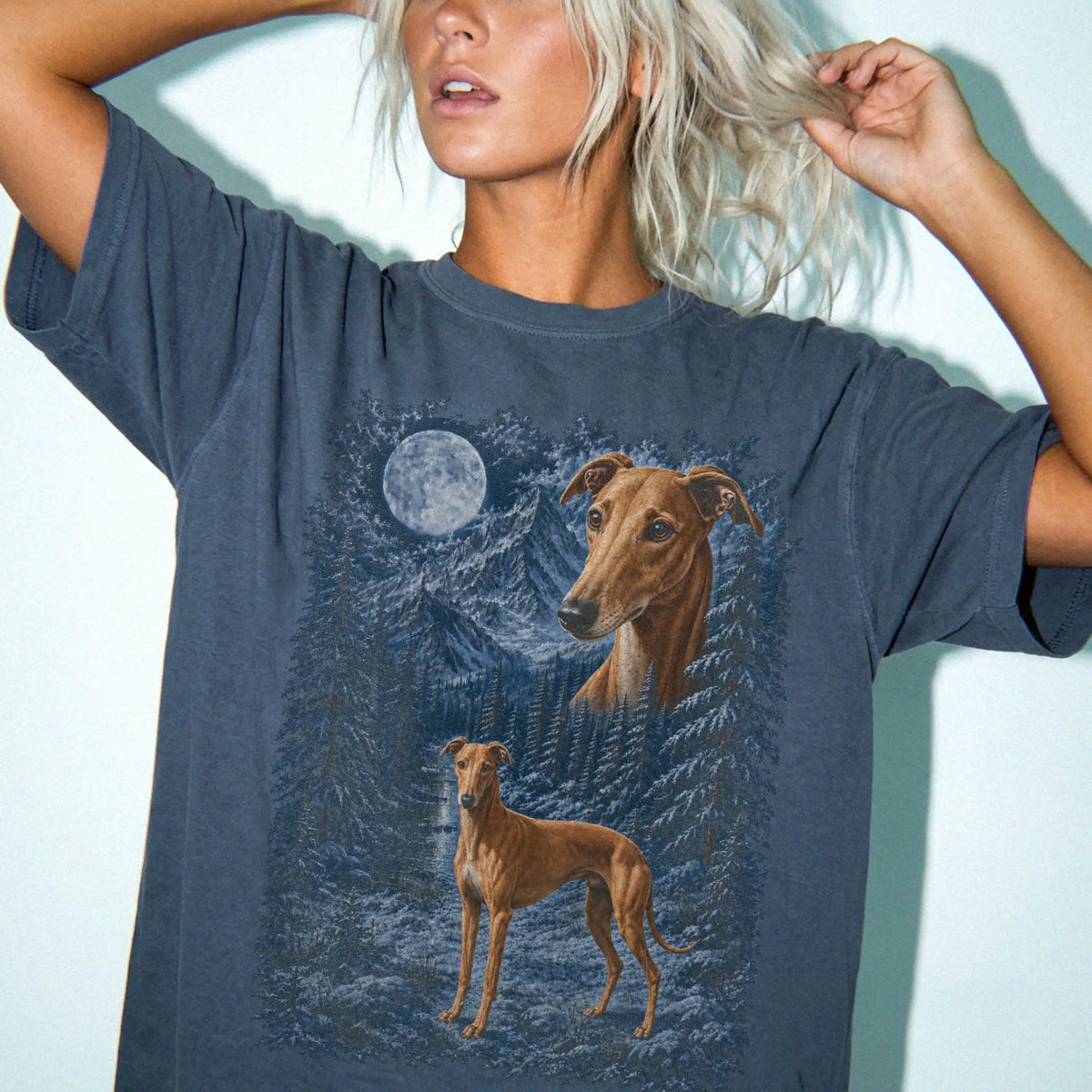 Person wearing a Denim Greyhound winter forest t-shirt