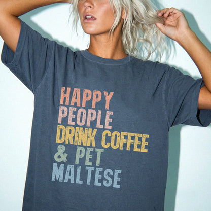 Model wearing a Denim Comfort Colors® T-shirt featuring Maltese with coffee and “Happy People Drink Coffee and Pet Dogs” lett