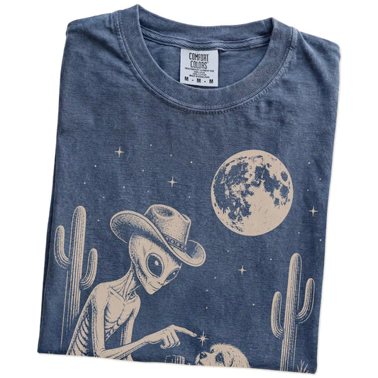 Folded Denim Comfort Colors® T-shirt showing cowboy alien fist-bumping a havanese beneath the moon