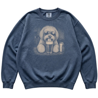 Denim Havanese drinking from a pint at a bar, laid flat