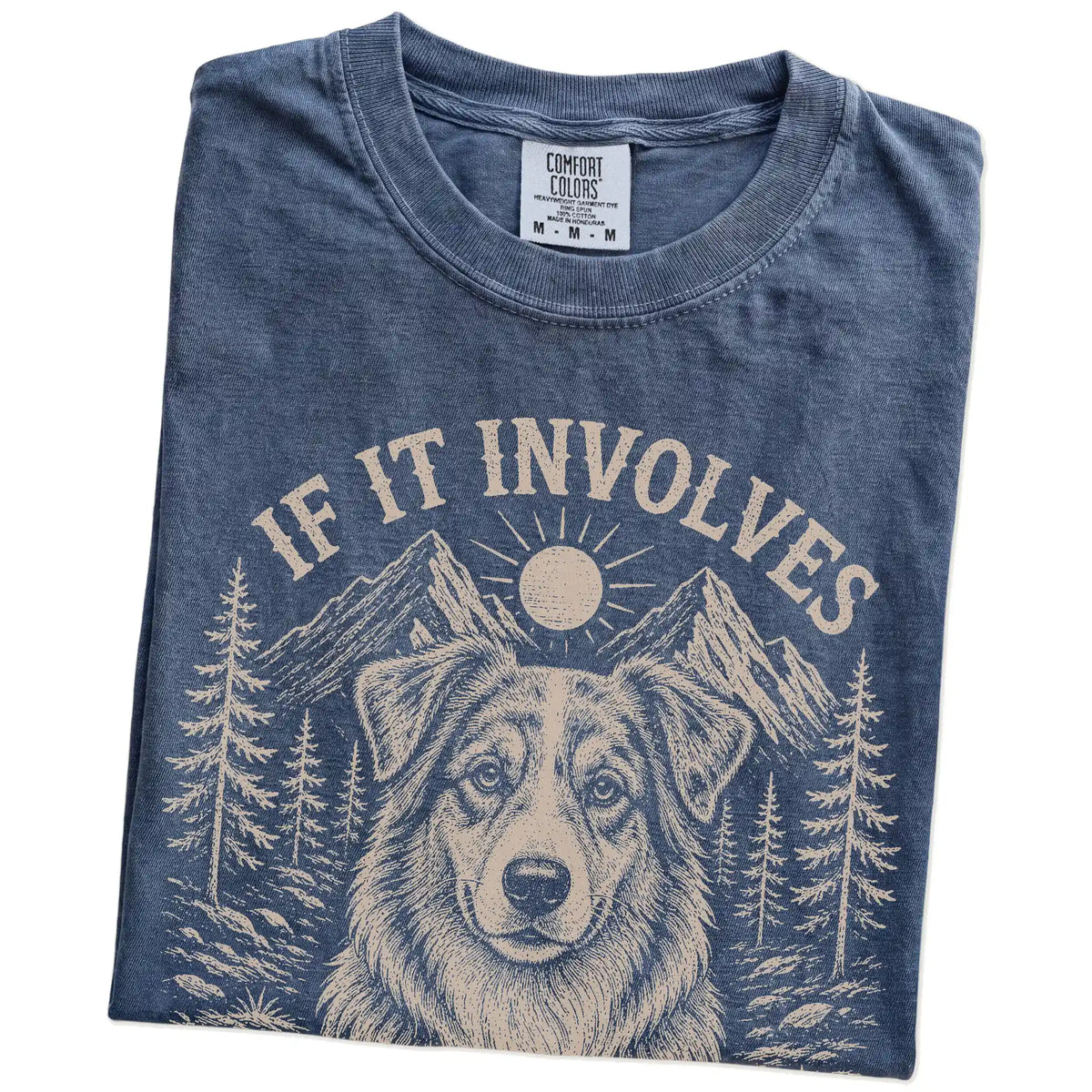 Folded Denim Comfort Colors® T-shirt showing Australian Shepherd hiking design with mountain scenery