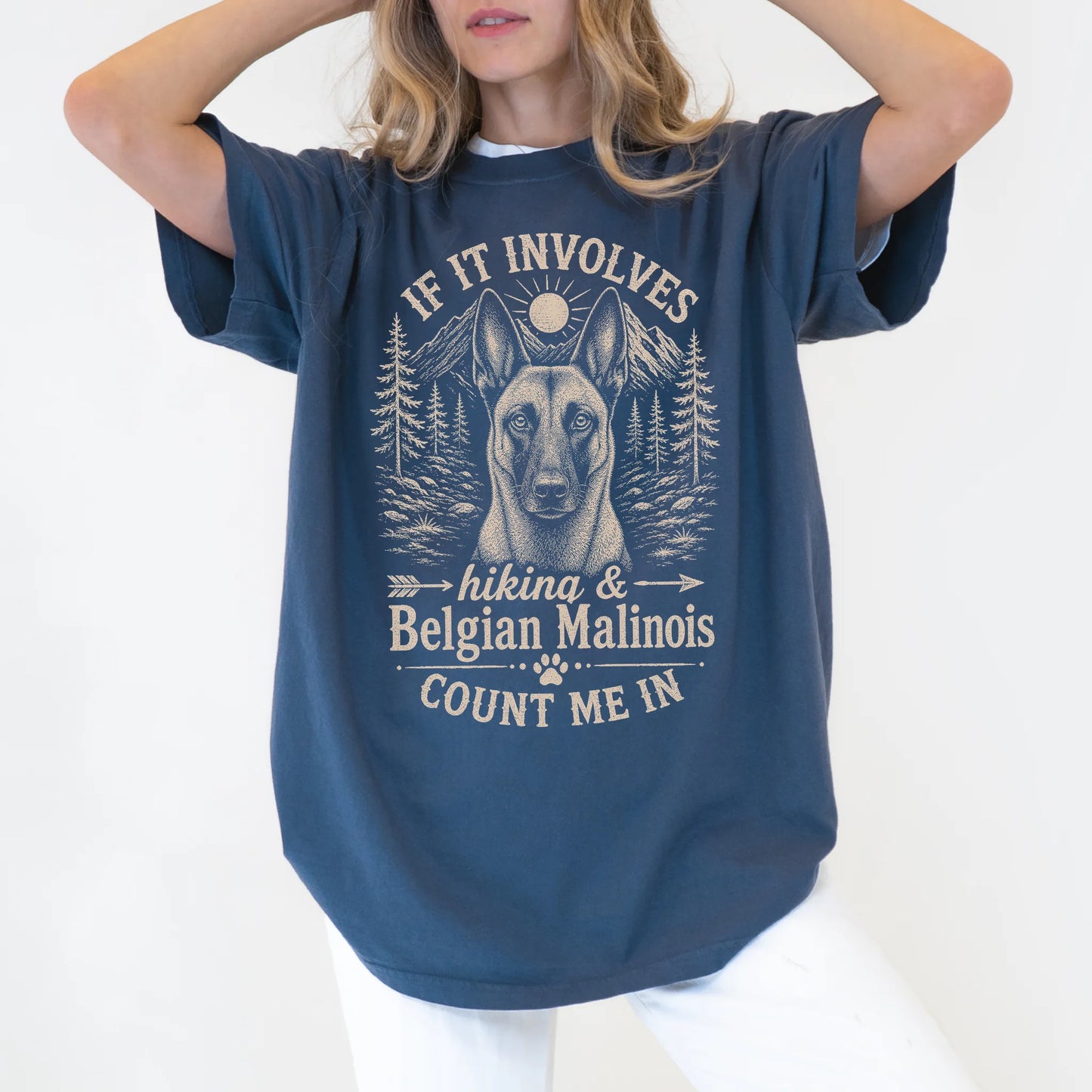 Model wearing a Denim Comfort Colors® T-shirt featuring Belgian Malinois hiking design with mountain scenery