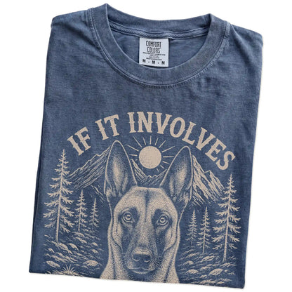 Folded Denim Comfort Colors® T-shirt showing Belgian Malinois hiking design with mountain scenery