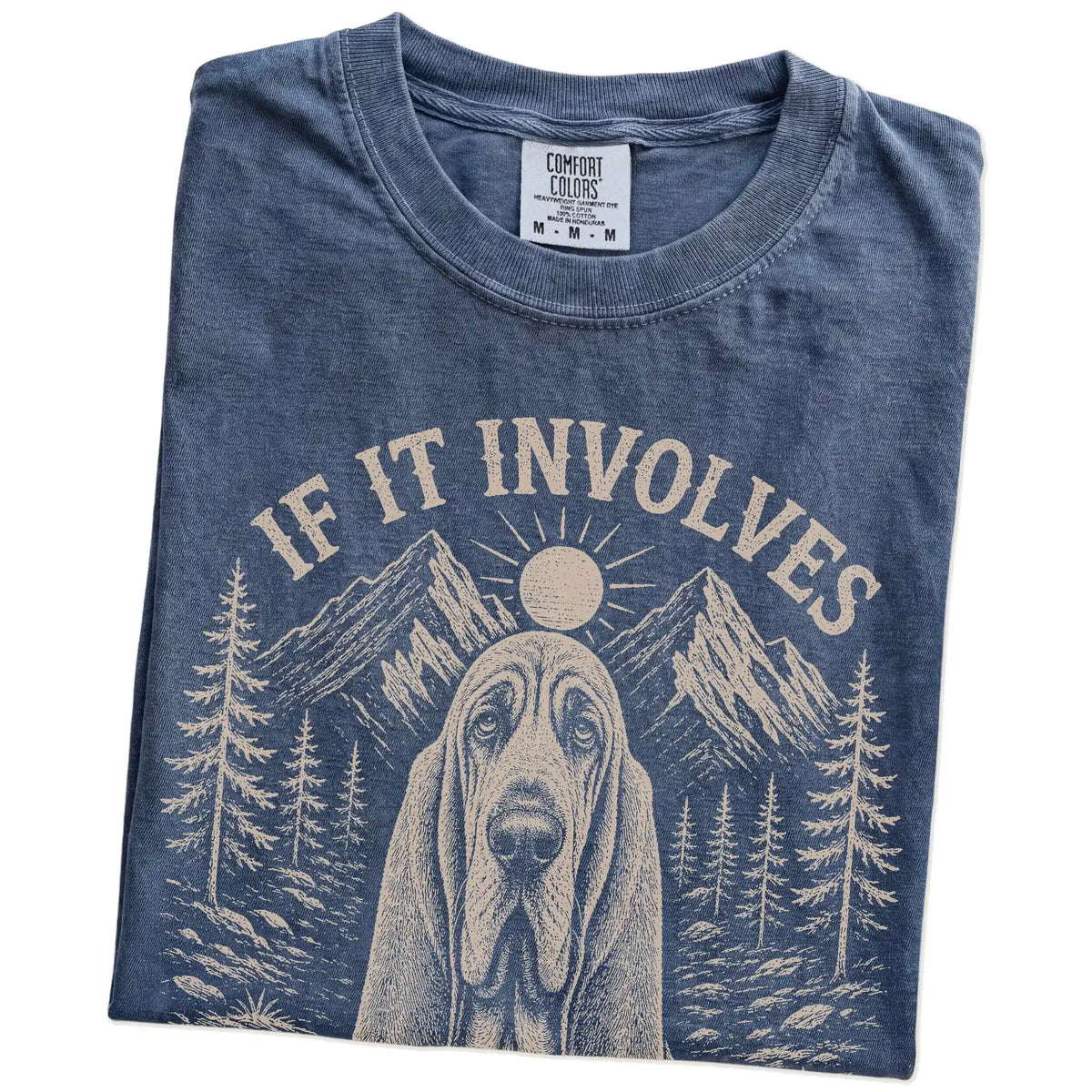Folded Denim Comfort Colors® T-shirt showing Bloodhound hiking design with mountain scenery