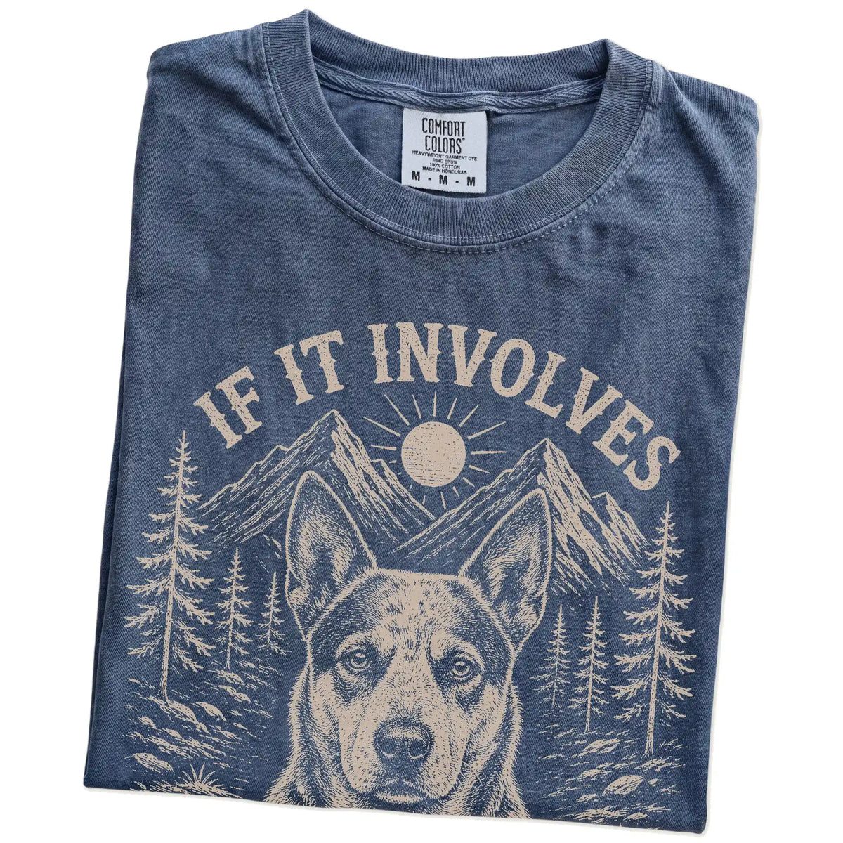 Folded Denim Comfort Colors® T-shirt showing Blue Heeler hiking design with mountain scenery