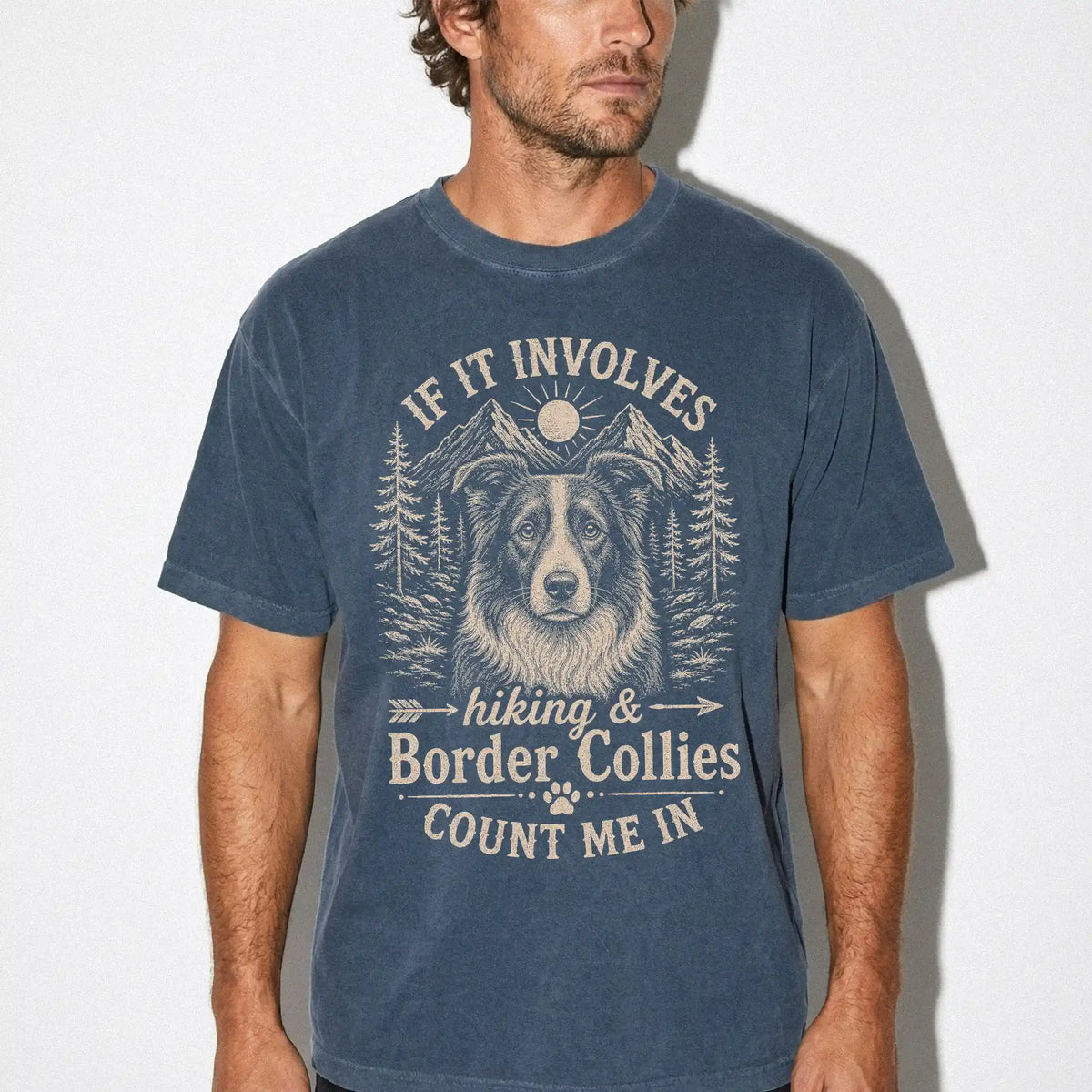 Model wearing a Denim Comfort Colors® T-shirt featuring Border Collie hiking design with mountain scenery