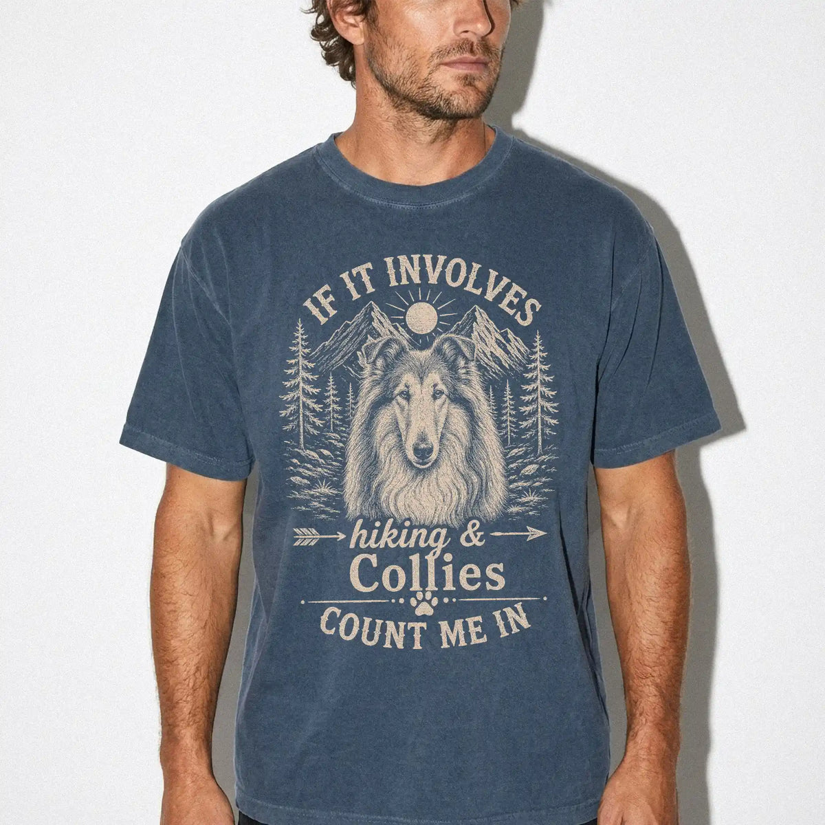 Model wearing a Denim Comfort Colors® T-shirt featuring Collie hiking design with mountain scenery