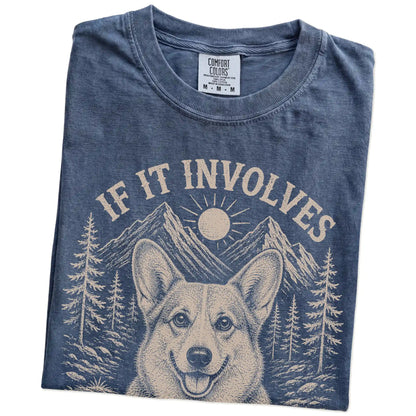 Folded Denim Comfort Colors® T-shirt showing Corgi hiking design with mountain scenery