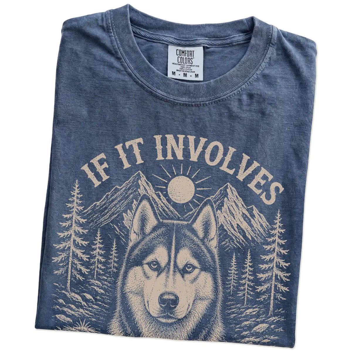 Folded Denim Comfort Colors® T-shirt showing Husky hiking design with mountain scenery