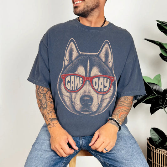 Model wearing a Denim Comfort Colors® T-shirt with husky wearing red game day sunglasses