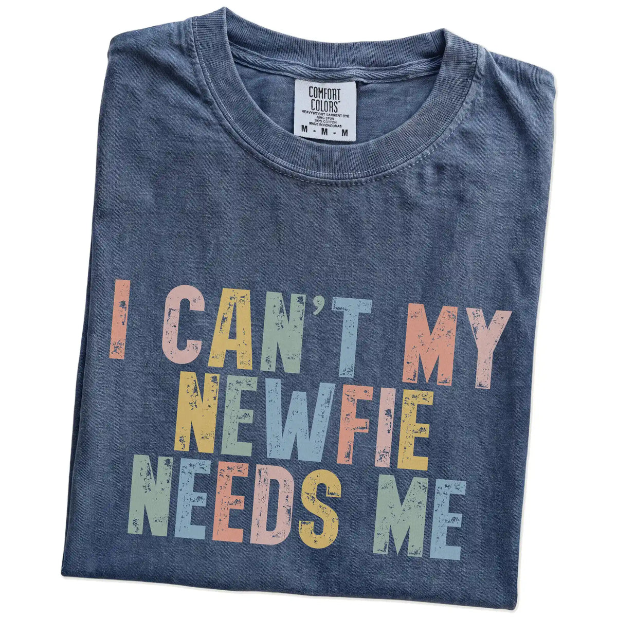Folded Denim Comfort Colors® T-shirt showing Newfie with “I Can’t, My Dog Needs Me” lettering