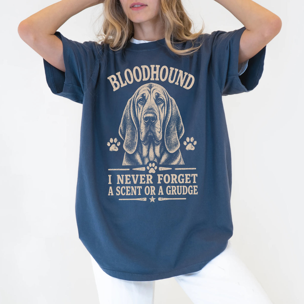 Model wearing a Denim Comfort Colors® T-shirt featuring Bloodhound design with “I Never Forget A Scent Or A Grudge” lettering