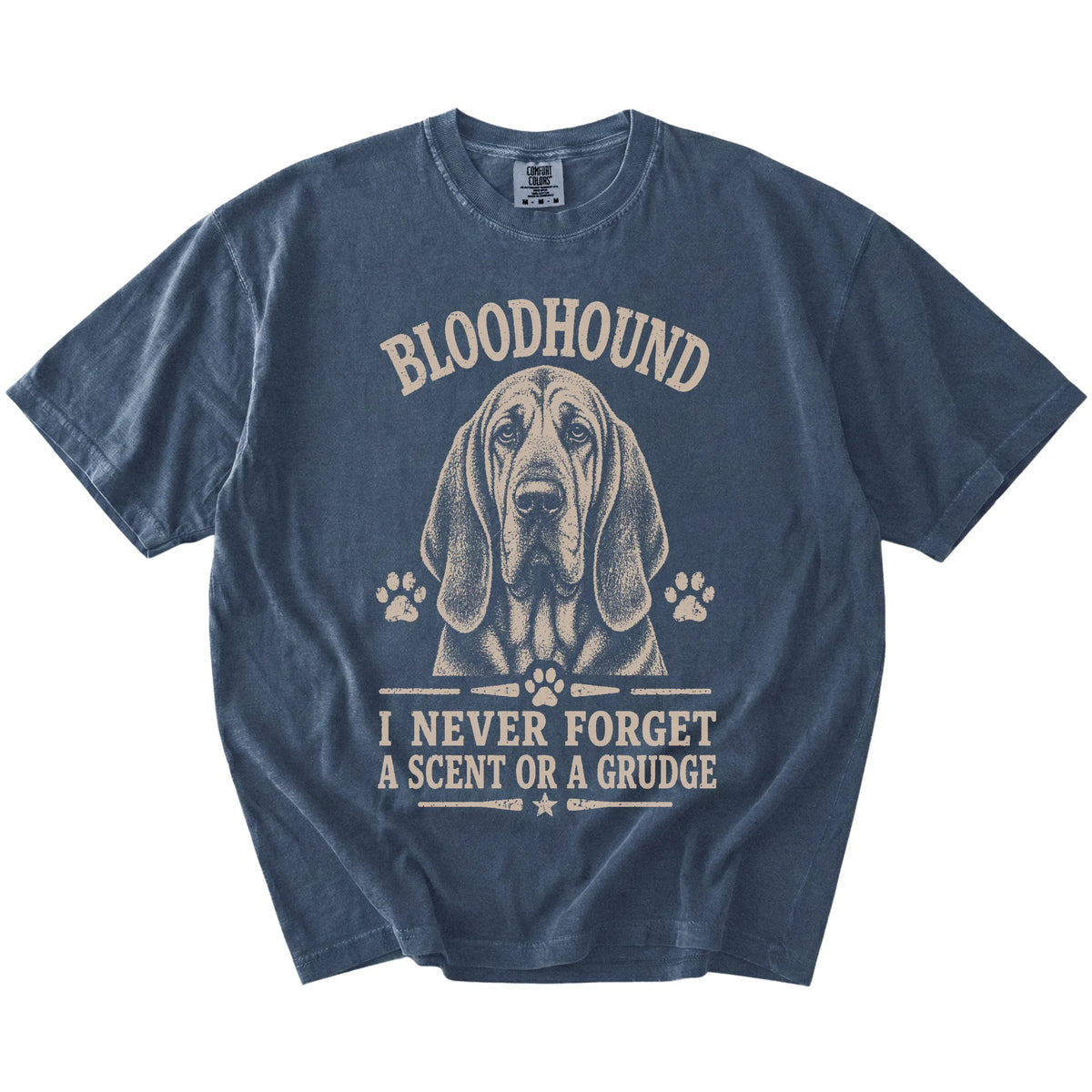 Bloodhound design with “I Never Forget A Scent Or A Grudge” lettering on a Denim Comfort Colors® T-shirt
