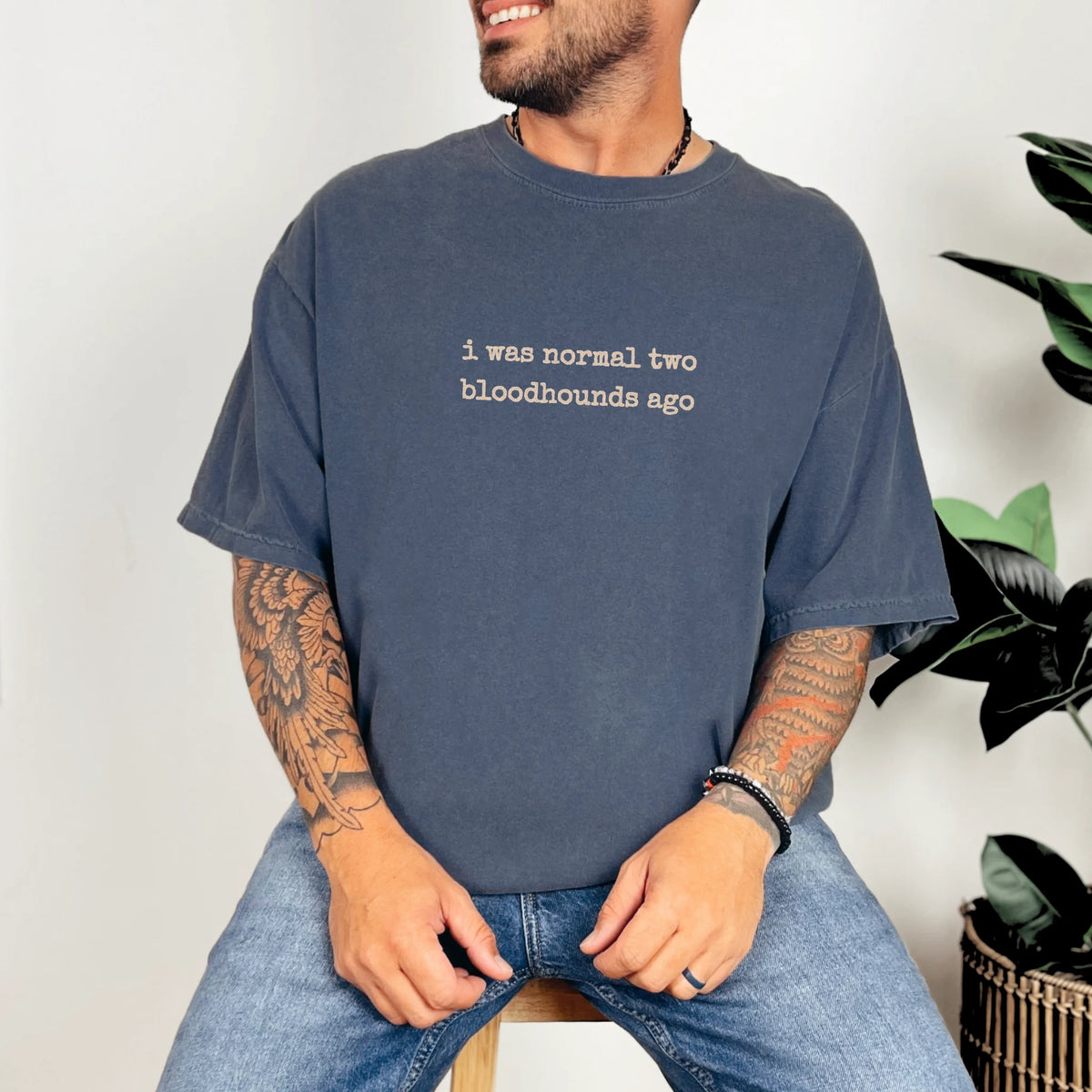 Model wearing a Denim Comfort Colors® T-shirt with i was normal two bloodhounds ago lettering