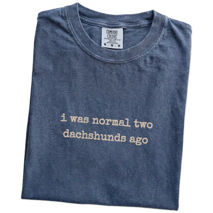 Folded Denim Comfort Colors® T-shirt showing i was normal two dachshunds ago lettering