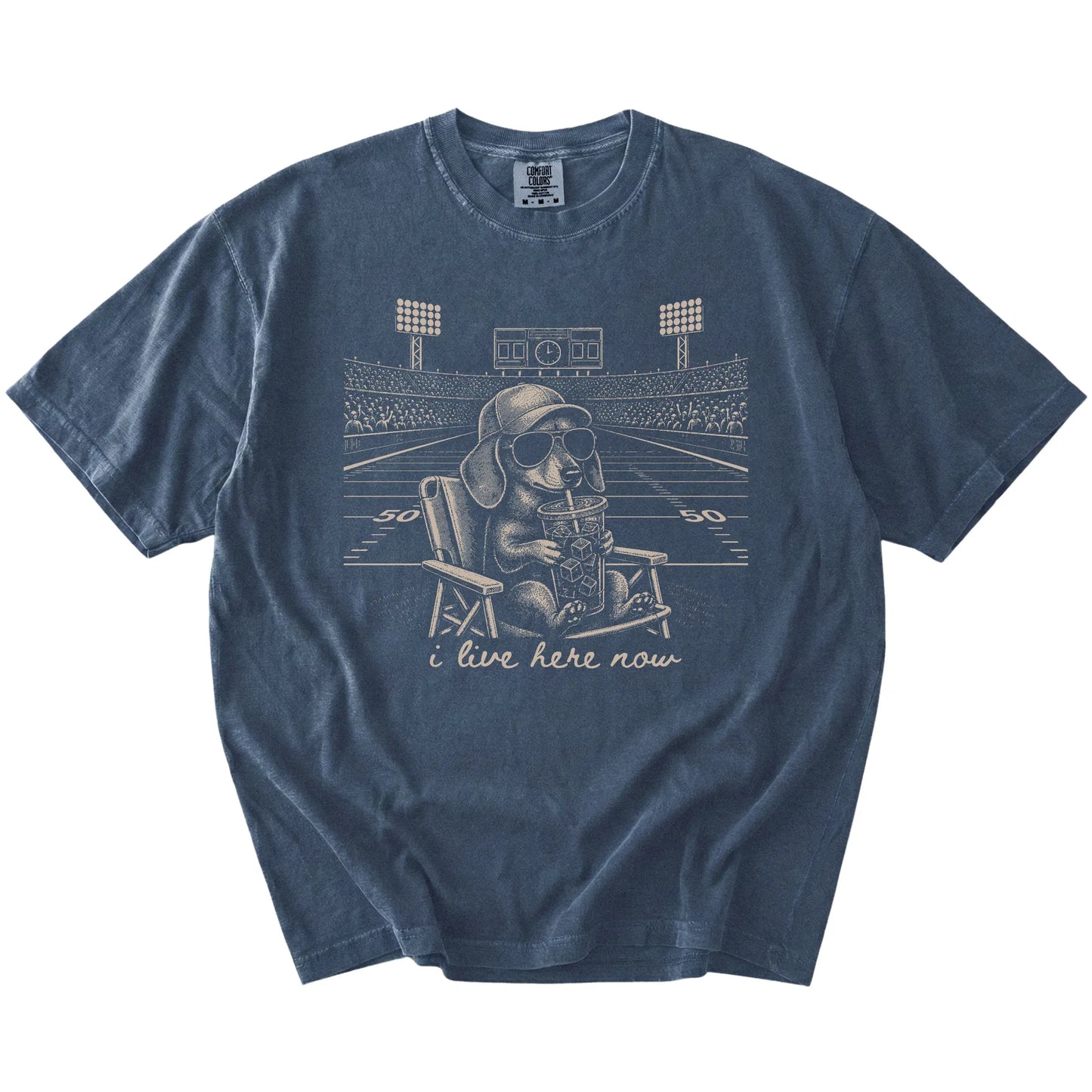 Dachshund claiming the football field with “I Live Here Now” lettering on a Denim Comfort Colors® T-shirt