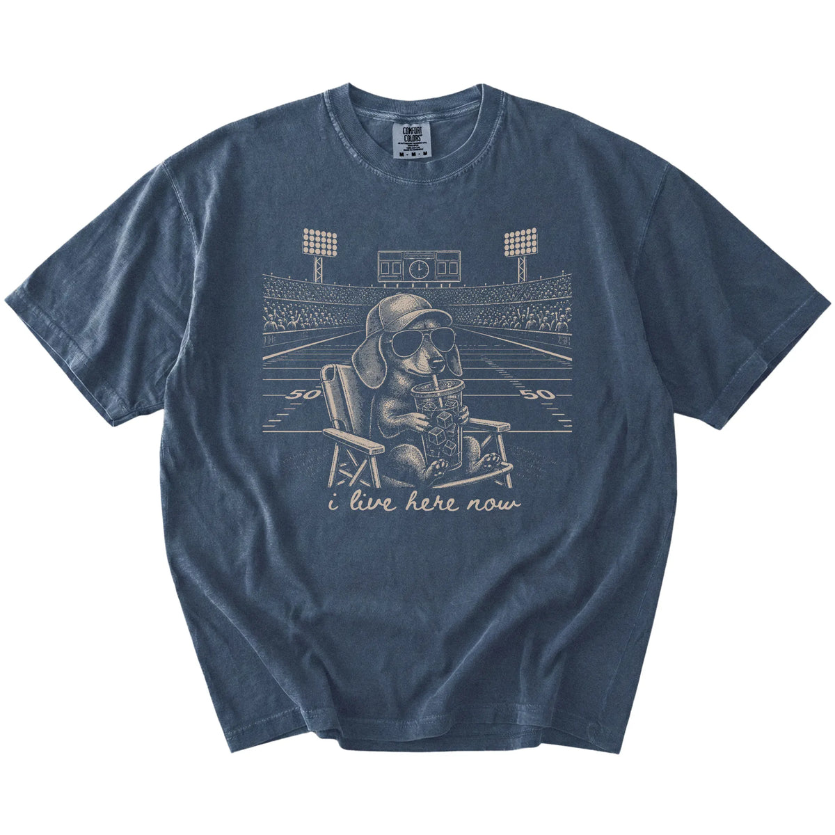 Dachshund claiming the football field with “I Live Here Now” lettering on a Denim Comfort Colors® T-shirt