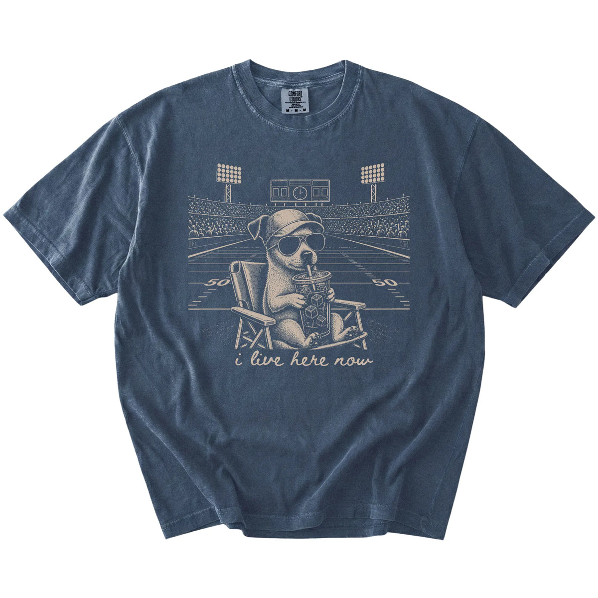 Jack Russell claiming the football field with “I Live Here Now” lettering on a Denim Comfort Colors® T-shirt