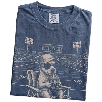 Folded Denim Comfort Colors® T-shirt showing Jack Russell claiming the football field with “I Live Here Now” lettering