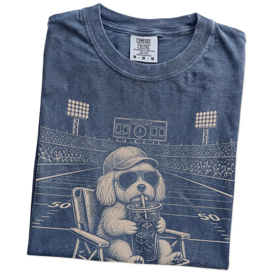 Folded Denim Comfort Colors® T-shirt showing Maltese claiming the football field with “I Live Here Now” lettering