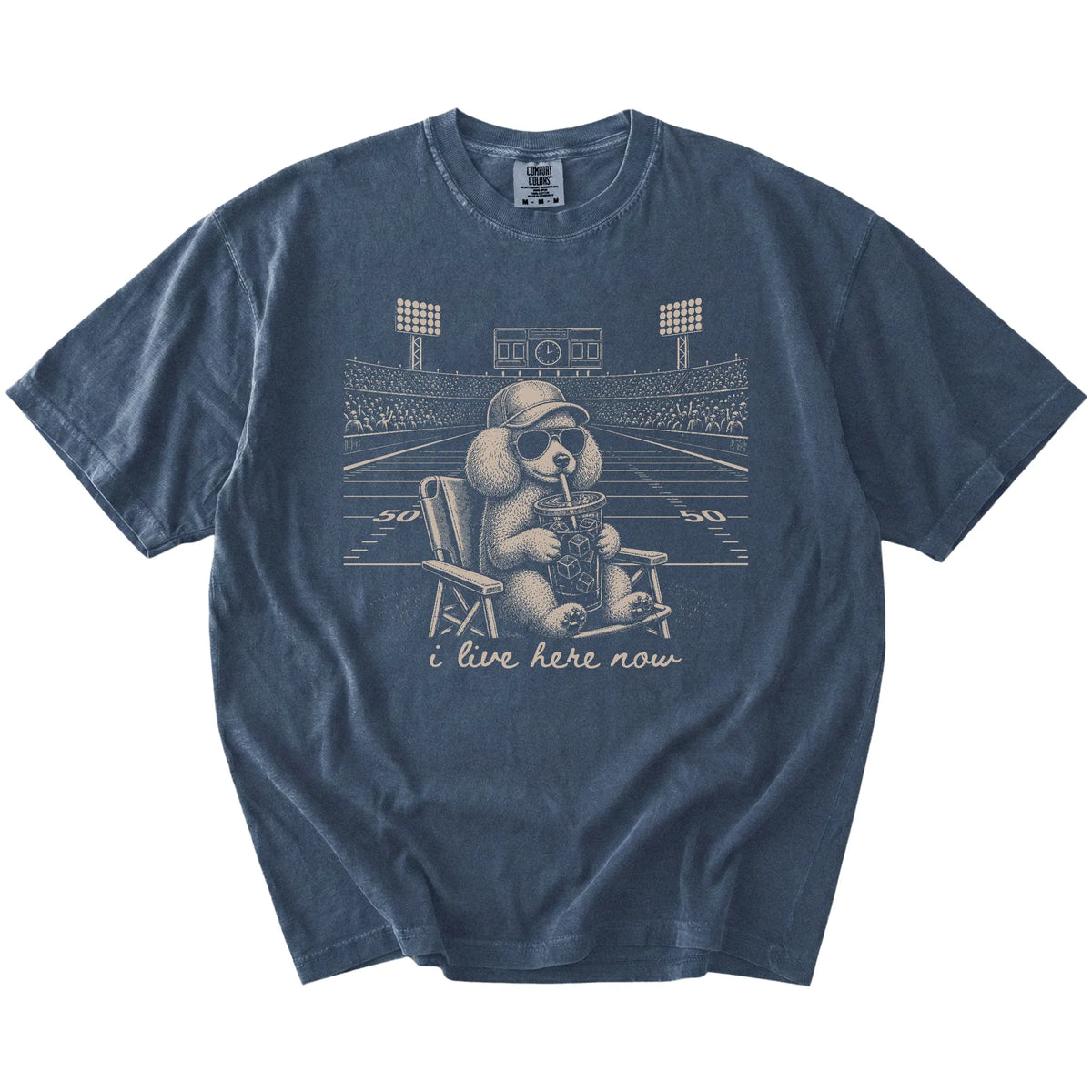 Poodle claiming the football field with “I Live Here Now” lettering on a Denim Comfort Colors® T-shirt