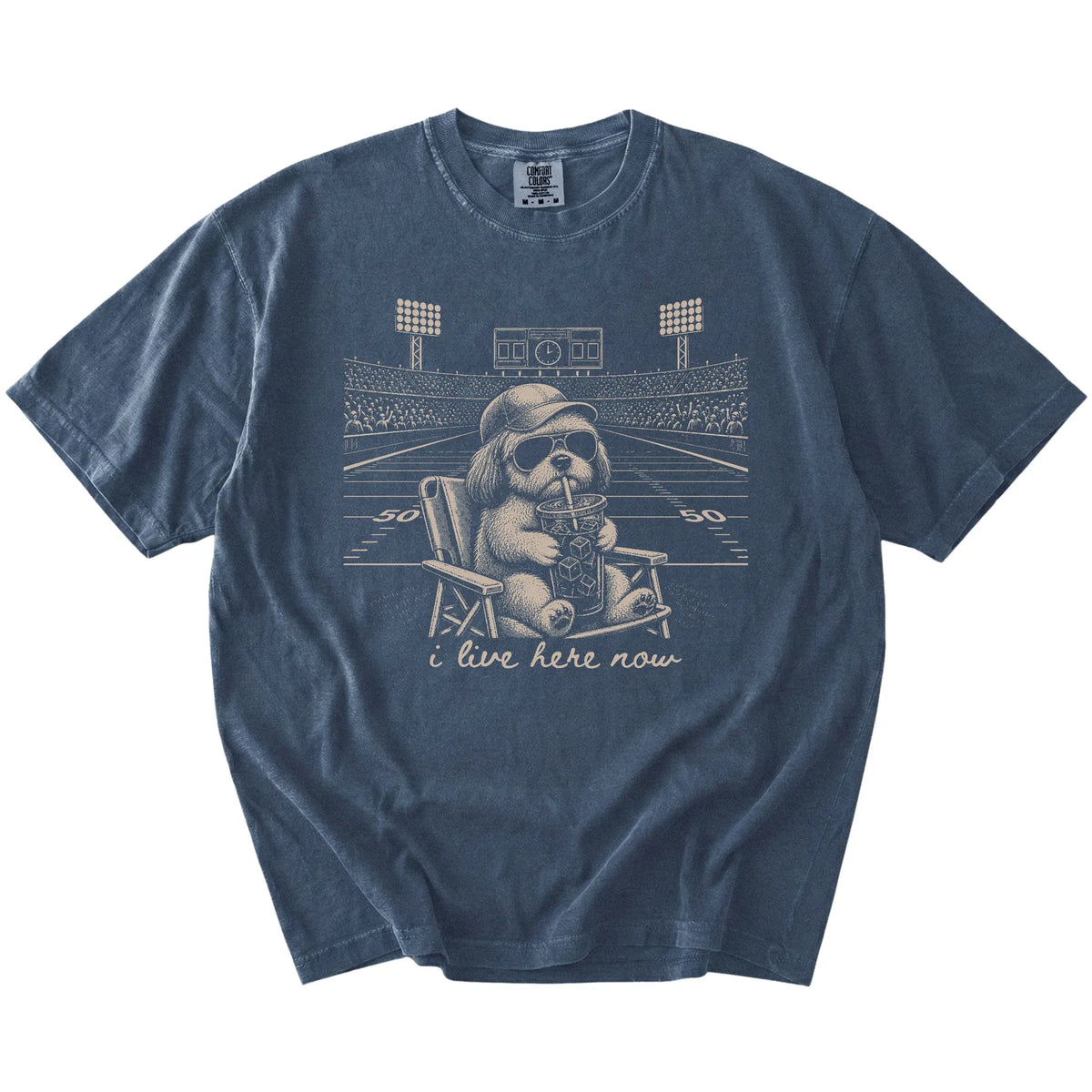 Shih Tzu claiming the football field with “I Live Here Now” lettering on a Denim Comfort Colors® T-shirt