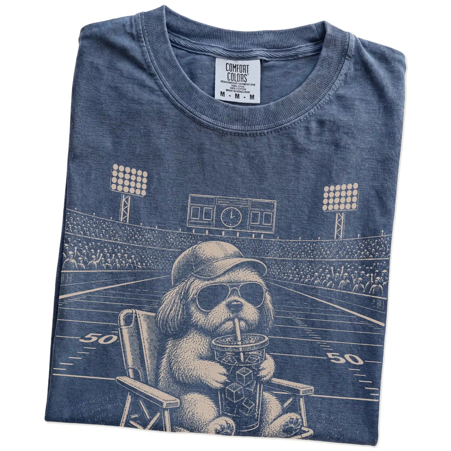 Folded Denim Comfort Colors® T-shirt showing Shih Tzu claiming the football field with “I Live Here Now” lettering