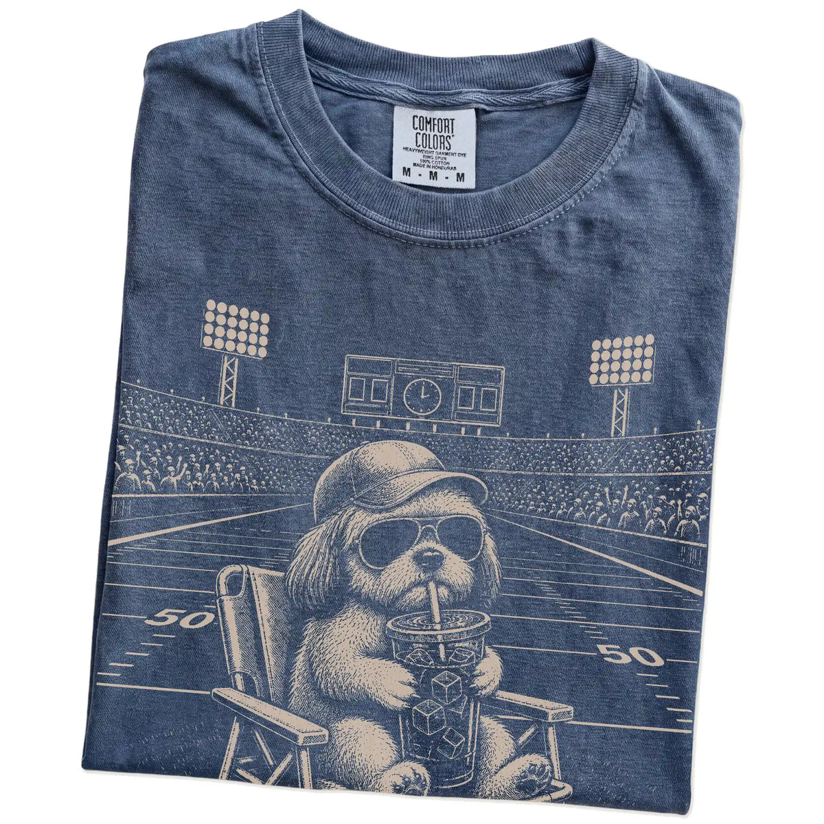 Folded Denim Comfort Colors® T-shirt showing Shih Tzu claiming the football field with “I Live Here Now” lettering