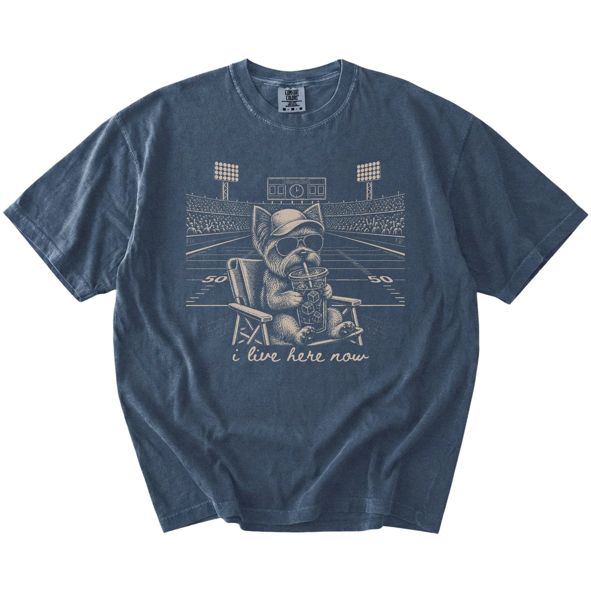 Yorkie claiming the football field with “I Live Here Now” lettering on a Denim Comfort Colors® T-shirt