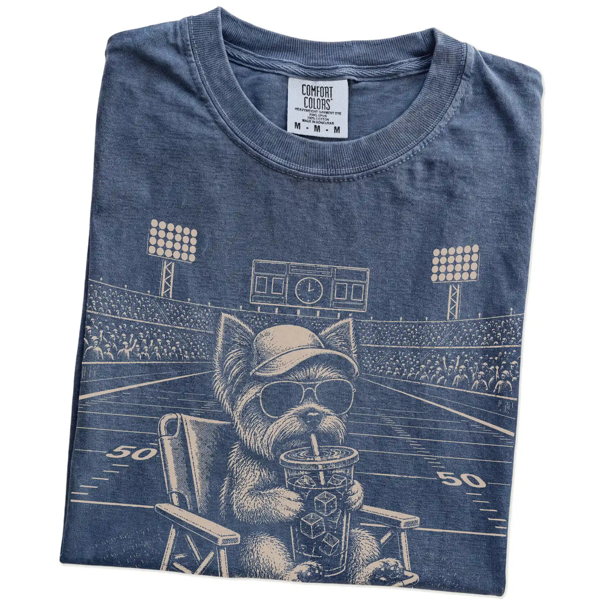 Folded Denim Comfort Colors® T-shirt showing Yorkie claiming the football field with “I Live Here Now” lettering