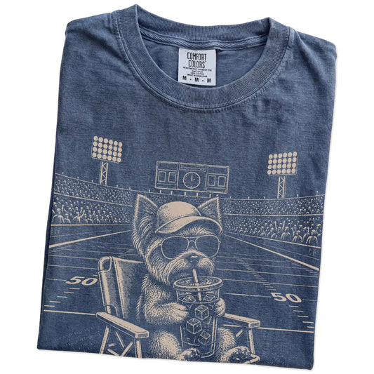 Folded Denim Comfort Colors® T-shirt showing Yorkie claiming the football field with “I Live Here Now” lettering